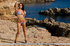 Tanned juicy brunette spreads her long legs apart