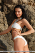 Wonderful brunette likes afternoon tanning by the beach