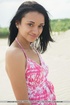 Exotic brunette has a playful time on sandy beach
