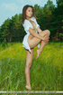 Cute teen plays in the sunny green grass meadow