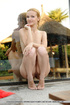Strawberry blonde takes a dip in the pool with her shaved beaver