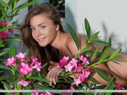 Playful young intern bares her neatly trimmed crotch