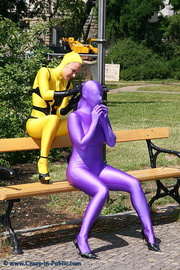 Two horny yellow and violett zentai wearing teens with a gorgeous ass walking outdoor.