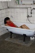 Nasty brunette gets tied and left in an old bathtub