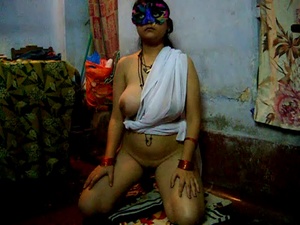 Busty Indian chick in a ponytail and a mask sucking man’s dick kneeling - Picture 1