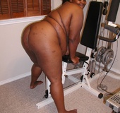 Pretty ebony BBW wife lying on the bed and exposing her soft goods.