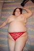 Busty BBW mom in tight red panties teasing in her bedroom.
