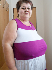 BBW in a striped dress demonstrating her milk farm - Picture 1