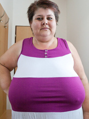 BBW in a striped dress demonstrating her milk farm - Picture 2