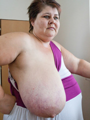 BBW in a striped dress demonstrating her milk farm - Picture 8