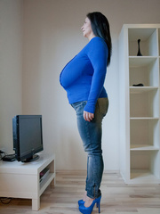 Brunette babe with huge juggs in jeans and blue pullover - Picture 8