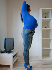 Brunette babe with huge juggs in jeans and blue pullover - Picture 9