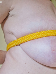Busty goddess topless having fun with a yellow rope - Picture 15