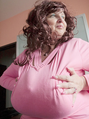 Curly brunette bbw in a pink pullover boasting with her - Picture 4