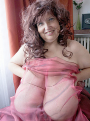 Curly brunette mature wrapped into pink transparent - Picture 6