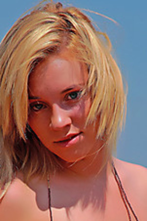 Blonde teen cutie posing absolutely nude in the rocks - Picture 2