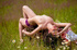 Pretty brunette chick looks inviting and sexy posing semi nude among wild