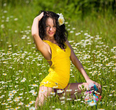 Sweet babe in sexy sunny yellow top strips to bask in the sun among the