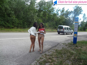 Two slutty moms lift up their skirt at the road to show off their cunts - Picture 2