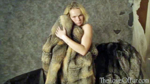 Nude blonde pin up trying on her new fur - Picture 2