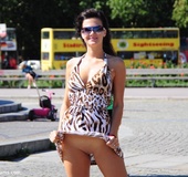 Dressy black haired beauty exposing her gorgeously formed ass in public.
