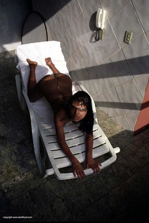 Swarthy teen babe sunbathing topless - Picture 5