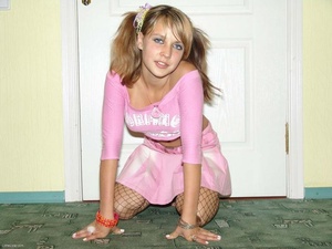 Pigtailed blonde teeny in fishnet tights takes off her clothing - Picture 8