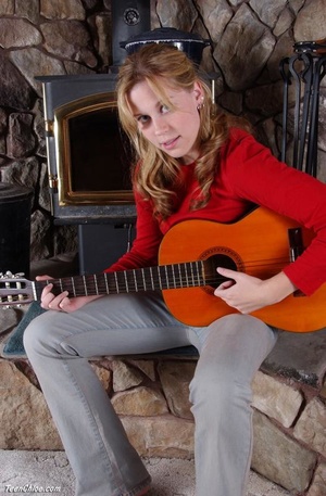 Cute blonde teeny undresses to pose with a guitar - Picture 1