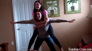 Playful girls in jeans picking up each other to show their strength - Picture 7