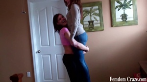 Playful girls in jeans picking up each other to show their strength - Picture 8
