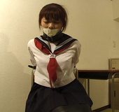 Ponytailed Asian college girl in uniform in special leather bondage trying