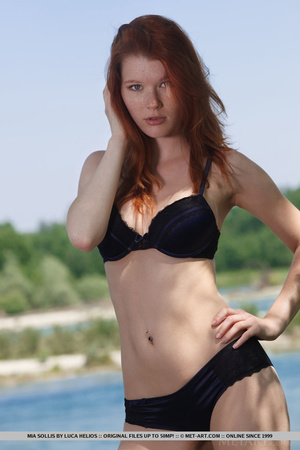 Young redhead takes off her bikini on th - Picture 1