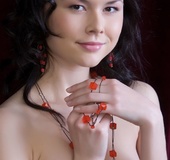 Attractive young Asian in red lingerie exposes her lush, trimmed pussy