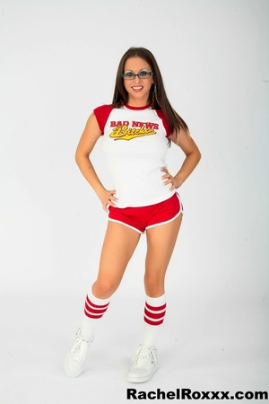 Hot seductress in hot cheerleader outfit and glasses shows hot butt and curves - Picture 1