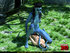 Striped blue female alien with a long tail strikes a soldier in the jungle