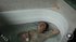 Lewd short-haired brunette teen gets high taking a water jet onto her