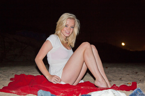 Lovely blonde teen relaxing on the red b - Picture 5