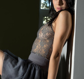 Dame with dark hair in grey lingerie fingers pussy on the chair and floor.