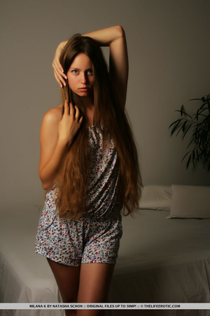 Brunette in a printed dress undresses an - Picture 3