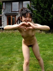 Nude youngster playing around on the lawn and on the deck.