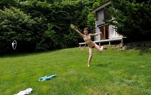 Nude youngster playing around on the lawn and on the deck. - Picture 15
