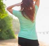 Brunette in the park lets you take a peek at her tits inside her gym clothes