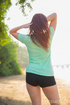 Brunette in the park lets you take a peek at her tits inside her gym clothes
