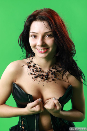 Lovely dish in a black corset exposes her muff on a green background. - XXXonXXX - Pic 10