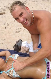 Dark-skinned girls in blue bikini fingered by a horny guy by the beachside.