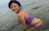 Ponytailed Asian cutie in undies and purple top swimming