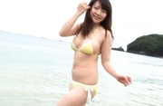 Busty Japanese teen in yellow lingerie and short skirt on the beach