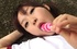 Pigtailed Japanese teen in school team uniform sucking a candy