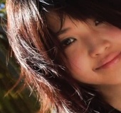 Petite Asian teen chick in a camouflage bikini posing at the sea shore