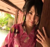 Hot Japanese seductress in a pink kimono posing on the floor
